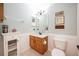 Clean bathroom with a single sink, toilet, and white vanity at 8773 Silk Bay Pl, Orlando, FL 32827