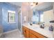 Elegant bathroom with dual sinks, a large mirror, and a walk-in shower at 8773 Silk Bay Pl, Orlando, FL 32827