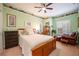 Cozy bedroom with a wooden bed frame, dresser, and seating area at 8773 Silk Bay Pl, Orlando, FL 32827