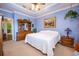 Bright bedroom featuring light blue walls, a comfortable bed, and ample natural light at 8773 Silk Bay Pl, Orlando, FL 32827