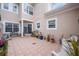Private courtyard with tile patio, mature plants, and seating at 8773 Silk Bay Pl, Orlando, FL 32827