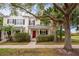 Inviting exterior of charming townhome with red door and lush landscaping at 8773 Silk Bay Pl, Orlando, FL 32827