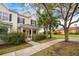 Two-story townhome with front porch, landscaped yard, and sidewalk at 8773 Silk Bay Pl, Orlando, FL 32827