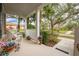 Inviting front porch with white wicker chairs and planters at 8773 Silk Bay Pl, Orlando, FL 32827