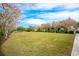 Expansive green space with mature trees and benches at 8773 Silk Bay Pl, Orlando, FL 32827