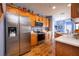 Modern kitchen with stainless steel appliances and wood cabinets at 8773 Silk Bay Pl, Orlando, FL 32827