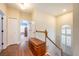 Upstairs hallway with wood floors, built-in storage, and access to bedrooms at 8773 Silk Bay Pl, Orlando, FL 32827