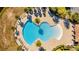 Aerial view of community pool with surrounding homes and lush landscape at 8906 Zurich Ln, Kissimmee, FL 34747