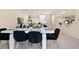 Modern dining room with white table and black velvet chairs at 8906 Zurich Ln, Kissimmee, FL 34747