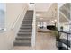 Bright entryway with gray carpeted stairs and view into living area at 8906 Zurich Ln, Kissimmee, FL 34747
