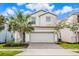 Two-story house with gray siding, gray garage door, and palm trees at 8906 Zurich Ln, Kissimmee, FL 34747