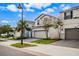 Houses with gray siding and gray garage doors on a tree-lined street at 8906 Zurich Ln, Kissimmee, FL 34747