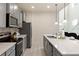 Modern kitchen with gray cabinets, quartz countertops and island at 8906 Zurich Ln, Kissimmee, FL 34747