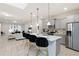 Modern kitchen with gray cabinets, quartz counters, and breakfast bar at 8906 Zurich Ln, Kissimmee, FL 34747