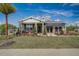 One story home with gray siding, stone accents, and awning at 9154 Harris Hawk Dr, Leesburg, FL 34788