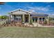 One story home with gray siding, stone accents, and awning at 9154 Harris Hawk Dr, Leesburg, FL 34788