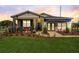 House exterior at sunset with landscaping and awning at 9154 Harris Hawk Dr, Leesburg, FL 34788