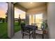 Covered patio with table and chairs, overlooking backyard at 9154 Harris Hawk Dr, Leesburg, FL 34788