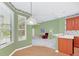 Eat-in kitchen with green walls and wood cabinets at 926 Palm Oak Dr, Apopka, FL 32712