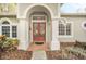 Home features double doors with arched entryway and brick walkway at 926 Palm Oak Dr, Apopka, FL 32712