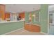 Kitchen with wood cabinets, breakfast bar, and access to pool at 926 Palm Oak Dr, Apopka, FL 32712