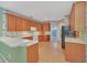 Spacious kitchen with wood cabinets, white appliances, and a breakfast bar at 926 Palm Oak Dr, Apopka, FL 32712