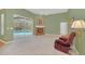 Living room with fireplace, pool view, and relaxing recliner at 926 Palm Oak Dr, Apopka, FL 32712