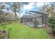 Enclosed pool with lush green backyard at 926 Palm Oak Dr, Apopka, FL 32712