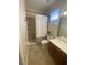 Bathroom with shower, toilet and brown vanity at 10433 Manderley Way # 267, Orlando, FL 32829