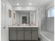 Double vanity bathroom with marble tile and bathtub at 1046 Splash Shot Pl, Davenport, FL 33896