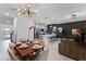 Open concept dining room and kitchen with modern light fixture and seating at 1046 Splash Shot Pl, Davenport, FL 33896