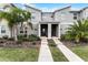 Modern two-story townhome with gray exterior, landscaping, and walkway at 1046 Splash Shot Pl, Davenport, FL 33896
