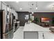 Modern kitchen features stainless steel appliances and a large island at 1046 Splash Shot Pl, Davenport, FL 33896