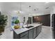 Modern kitchen with island, stainless steel appliances, and breakfast bar at 1046 Splash Shot Pl, Davenport, FL 33896