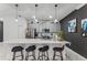 Modern kitchen with gray cabinets, white countertops, and island seating at 1046 Splash Shot Pl, Davenport, FL 33896