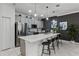 Modern kitchen with gray cabinets, white countertops, and island seating at 1046 Splash Shot Pl, Davenport, FL 33896