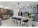 Modern kitchen with gray cabinets, white countertops, and breakfast bar at 1046 Splash Shot Pl, Davenport, FL 33896