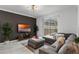 Open living room featuring a sectional sofa, large TV, and pool view at 1046 Splash Shot Pl, Davenport, FL 33896