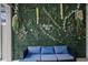 Relaxing patio with a blue sofa and a floral wall at 1046 Splash Shot Pl, Davenport, FL 33896