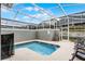 Shared, screened-in pool with lounge chairs at 1046 Splash Shot Pl, Davenport, FL 33896