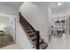 Stylish interior staircase with dark wood railing and carpet runner at 1046 Splash Shot Pl, Davenport, FL 33896