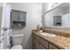 Well-lit bathroom with granite countertops, ample storage, and stylish gray cabinets at 1057 S Hiawassee Rd # 1911, Orlando, FL 32835