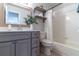 Bathroom featuring gray vanity with white top, wood-trimmed mirror, and white tub and shower combo at 1057 S Hiawassee Rd # 1911, Orlando, FL 32835