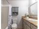 Well-lit bathroom features a granite vanity, cabinet, and shower with a decorative floral curtain at 1057 S Hiawassee Rd # 1911, Orlando, FL 32835