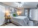 Relaxing bedroom featuring a queen-size bed, accent lamps, and large windows for natural light at 1057 S Hiawassee Rd # 1911, Orlando, FL 32835