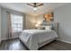 Comfortable bedroom with a ceiling fan, bright window, and soft, natural light at 1057 S Hiawassee Rd # 1911, Orlando, FL 32835
