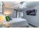 Inviting bedroom offers a plush bed, ceiling fan, and natural light with a view of the balcony at 1057 S Hiawassee Rd # 1911, Orlando, FL 32835