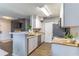 Modern kitchen featuring white cabinets, stainless steel appliances, and granite countertops at 1057 S Hiawassee Rd # 1911, Orlando, FL 32835