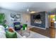 Open living room with a gray brick accent wall and hardwood flooring at 1057 S Hiawassee Rd # 1911, Orlando, FL 32835
