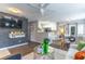Open living room with stylish decor, brick wall, ceiling fan, and hardwood floors at 1057 S Hiawassee Rd # 1911, Orlando, FL 32835